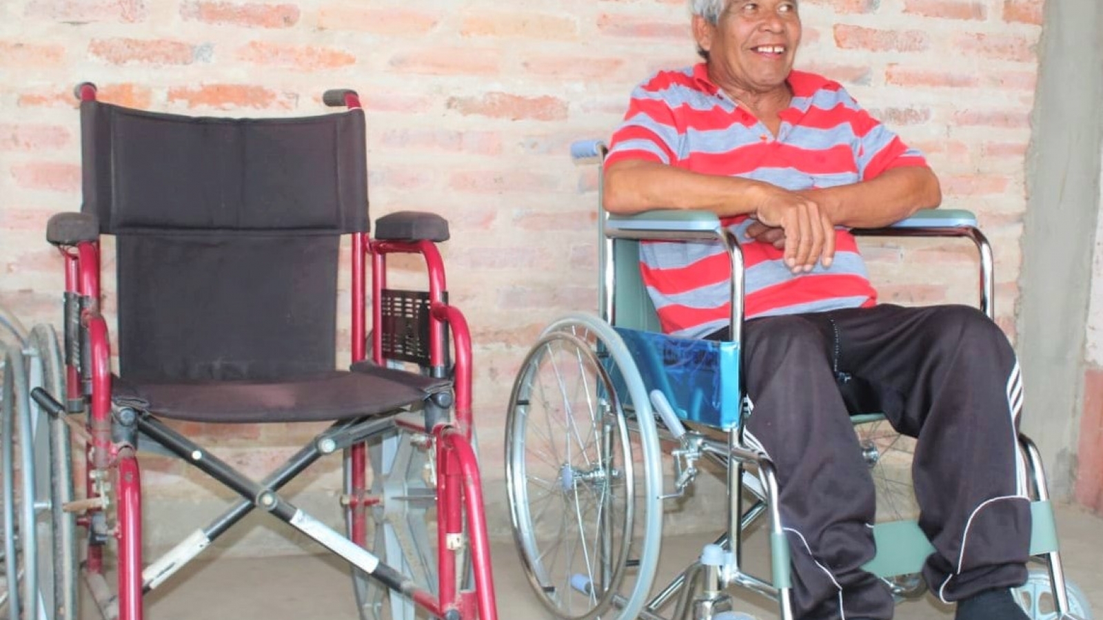Persona con discapacidad sentada en su nueva silla de ruedas